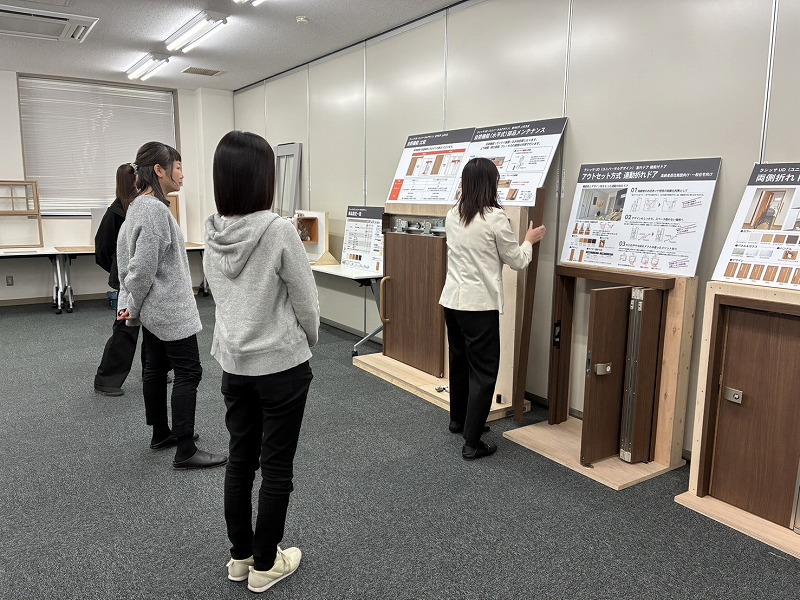 建築工房いろはが開催する注文住宅の勉強会で、参加者が建材や仕様サンプルを前に説明を受けながら家づくりについて学んでいる様子を撮影した写真で、工務店による住まい計画の情報提供の場を表している。